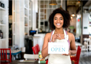 woman holding open sign