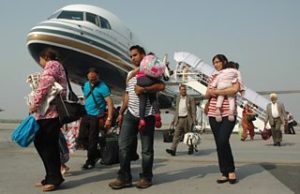 forced migrants standing by plane